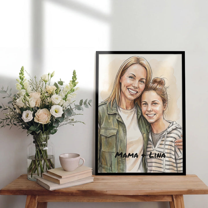 Aquarell-Poster von Mama und Tochter im schwarzen Rahmen auf einem Holztisch mit Blumen