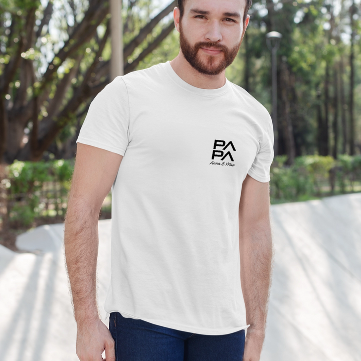 Man wearing Personalisiertes Papa T-Shirt Modern, standing outdoors, showcasing its customizable feature for adding children's names, ideal for a heartfelt gift.